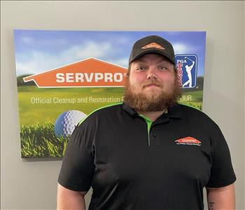 A male SERVPRO employee is shown in a black shirt with SERVPRO logo