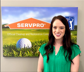 Female SERVPRO marketing manager Erika is shown in front of SERVPRO logo 