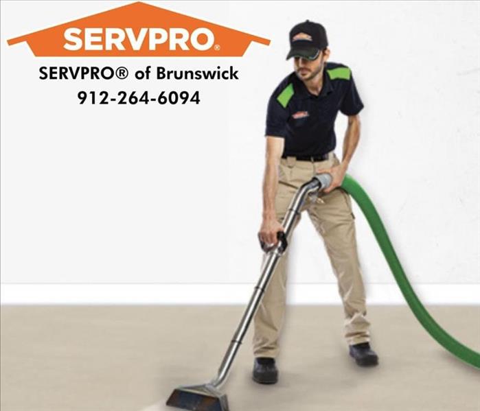 A SERVPRO technician is shown cleaning a floor the SERVPRO log is shown with Brunswick number (912) 264-6094
