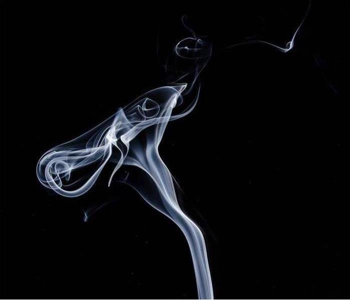 Smoke is shown over a black background