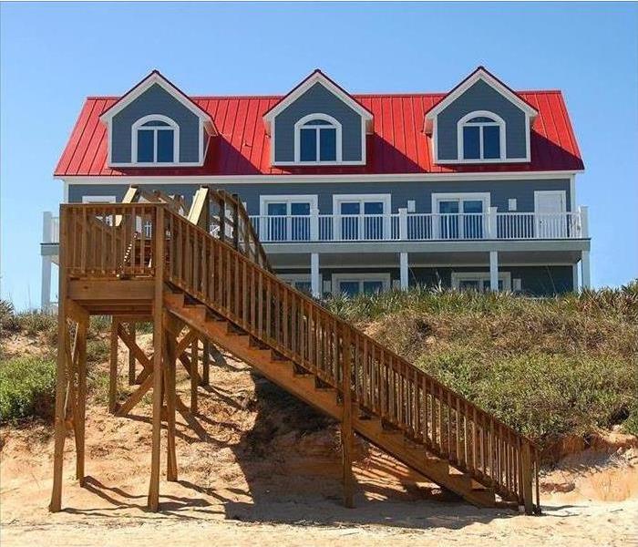 Stairs leading to a beach house are shown 