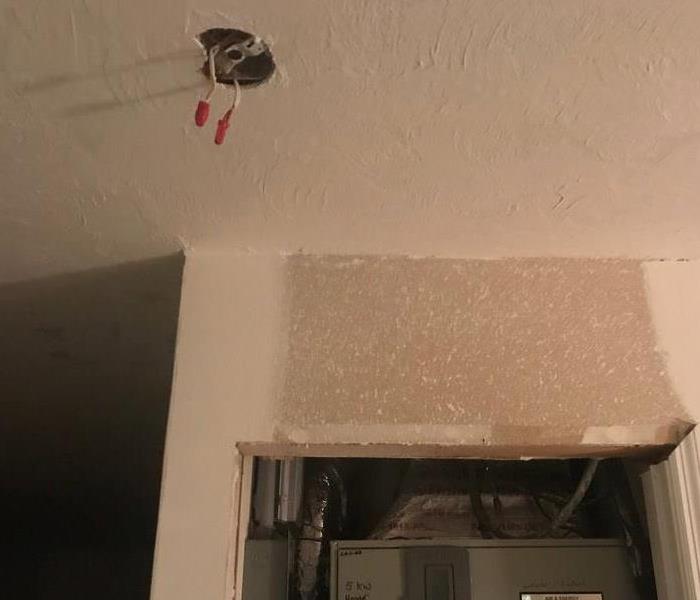 Faulty electrical wiring is shown in a ceiling